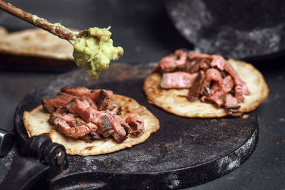 High angle view of meat in cooking pan on table