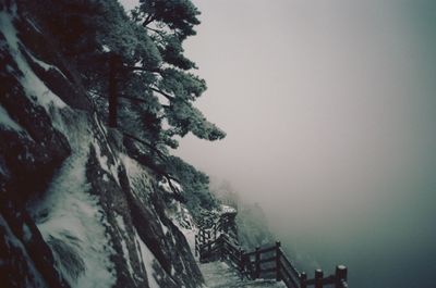 High angle view of steps by mountain during foggy weather in winter