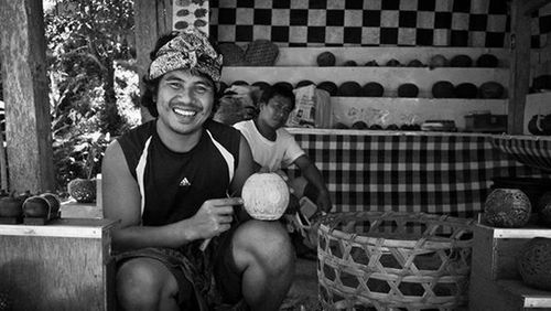 Portrait of a smiling young man sitting outdoors