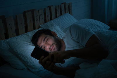 Men lie in bed and play the phone all the time. addicted to social media, no time to relax.