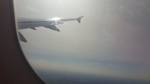 Close-up of airplane wing against sky