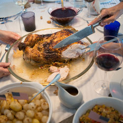 Human hand serving christmas turkey. side dishes on the table. spain