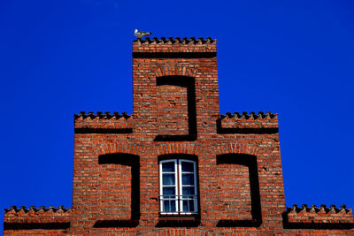 Low angle view of historical building against clear blue sky