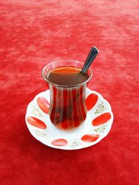 Close-up of drink in glass on red table