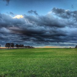 Scenic view of landscape against cloudy sky