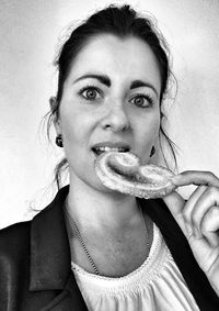 Close-up portrait of young woman eating