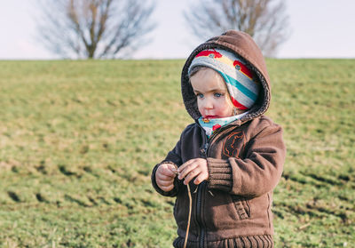 Portrait of cute girl in snowy field