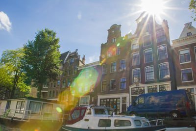 Low angle view of cars in city against sky