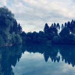 Reflection of trees in lake against sky