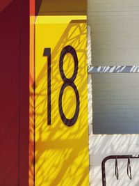 Close-up of yellow sign on wall