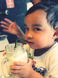 Close-up of boy drinking glass