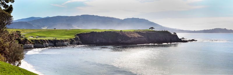 Panoramic view of sea and cliff against sky