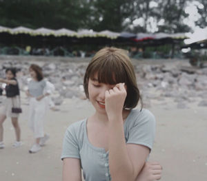 Side view of young woman standing on road