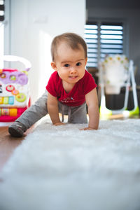 Baby on all fours in bright room. baby development concept.