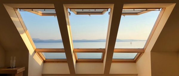 Low angle view of sea seen through window