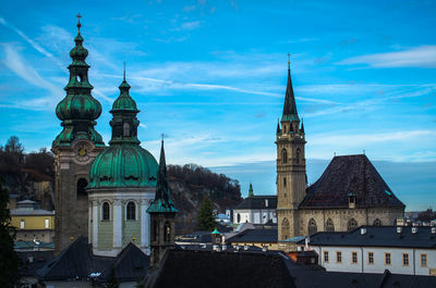 Churches in city against sky