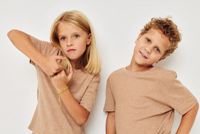 Portrait of sibling against white background