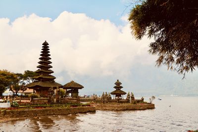 Temple by building against sky