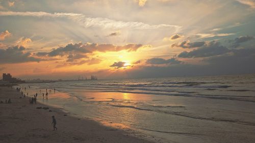 Scenic view of beach against sky during sunset