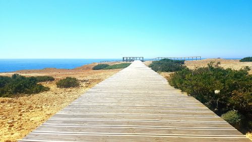 Narrow walkway leading towards sea