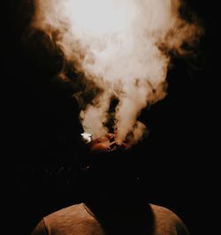 Midsection of man smoking at home