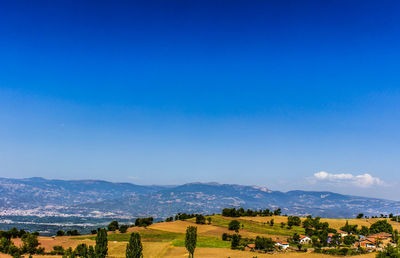 Scenic view of landscape against blue sky