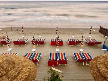 High angle view of chairs on beach against sky