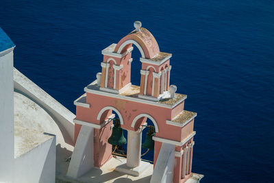 High angle view of building by sea against blue sky