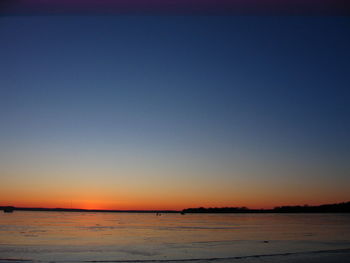 Scenic view of sea against clear sky at sunset