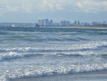 Scenic view of sea and buildings against sky