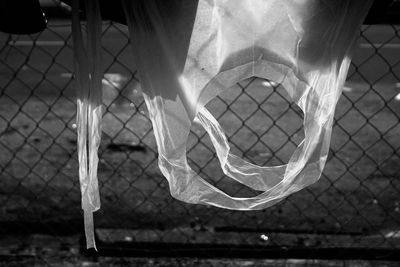 Low section of man standing by fence