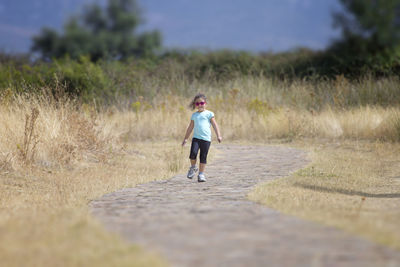 Rear view of man walking on field