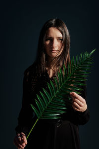 Woman portrait with palm leaf in hand