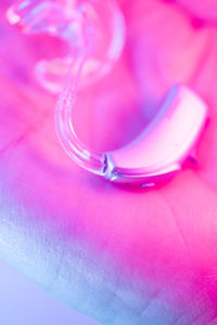High angle view of wedding rings on pink flower