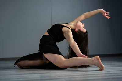 Full length of dancer dancing in studio