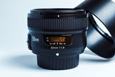Close-up of camera on table against white background