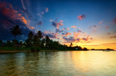 Scenic view of lake against sky at sunset