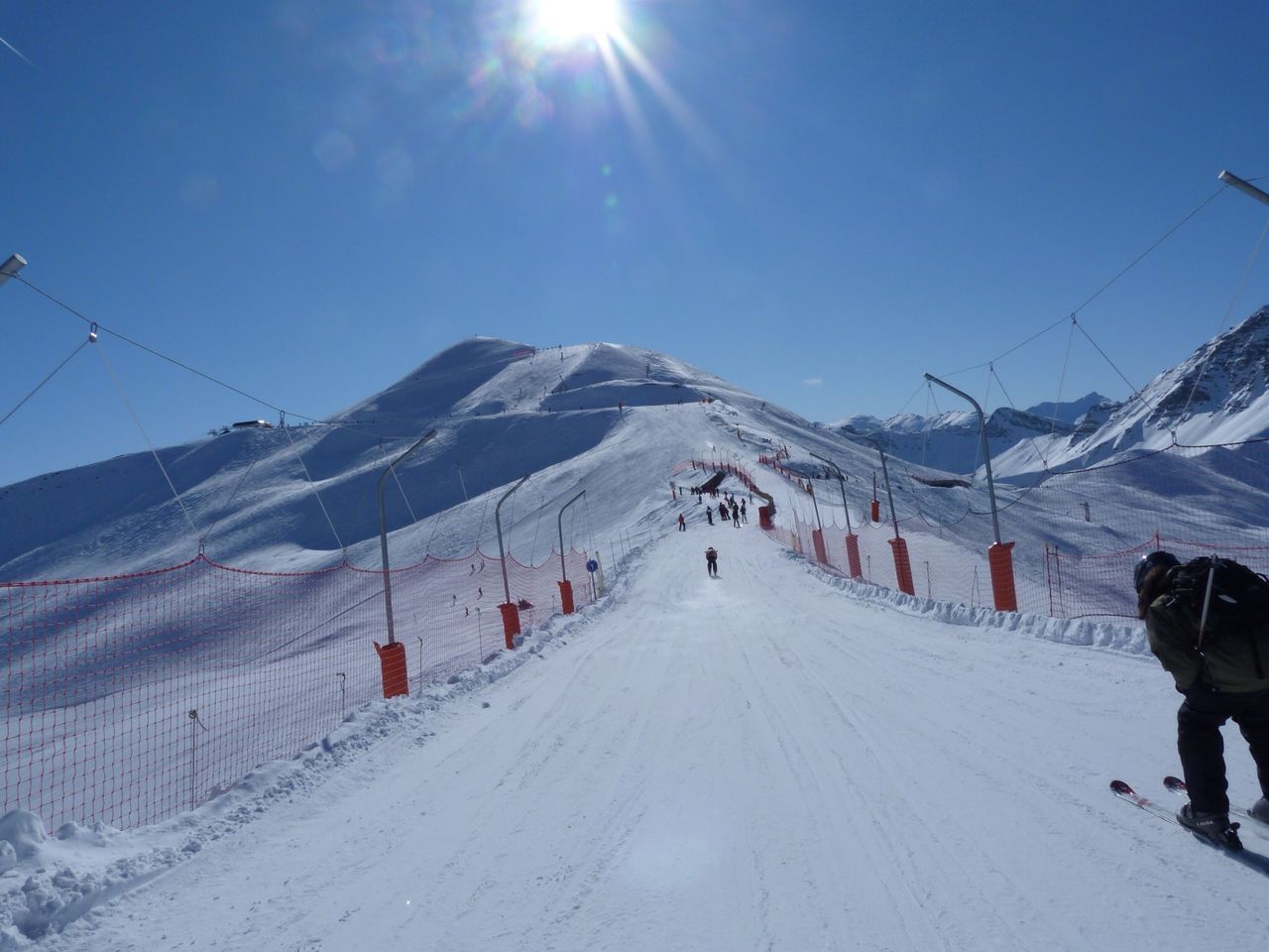 snow, cold temperature, winter, season, mountain, the way forward, weather, snowcapped mountain, landscape, skiing, sunlight, transportation, covering, blue, leisure activity, sky, sun, mountain range, nature