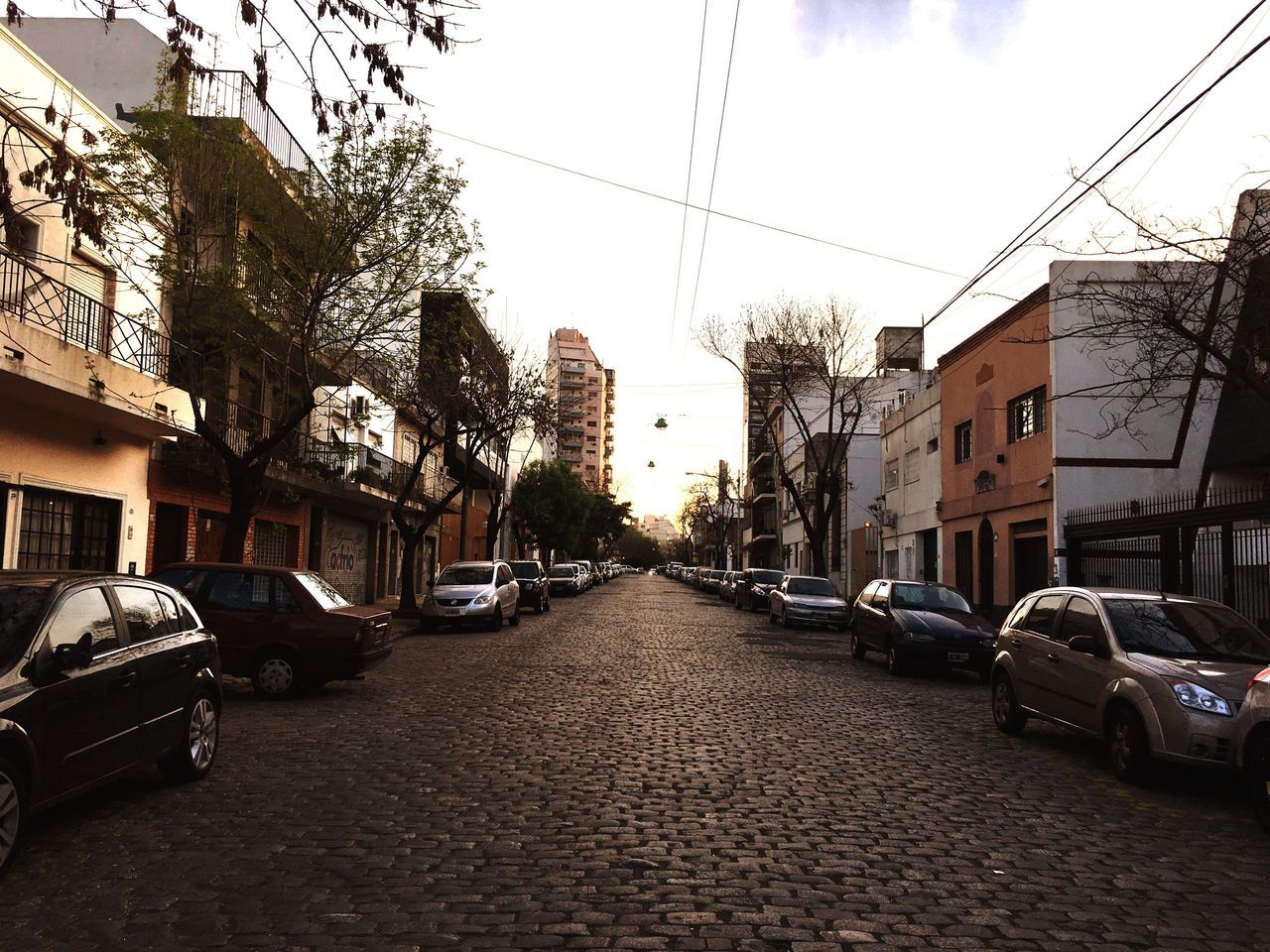 CARS PARKED ON ROAD IN CITY