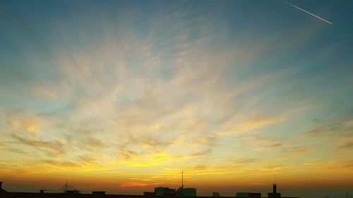 Low angle view of silhouette buildings against sky during sunset