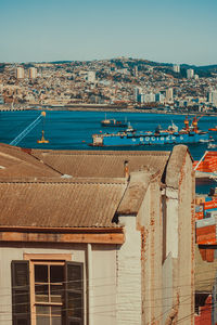 High angle view of townscape by sea against sky