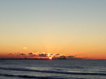 Scenic view of sea against orange sky