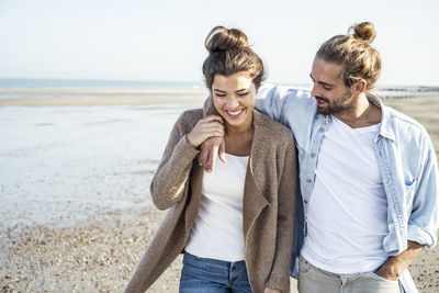 Young couple standing on beach