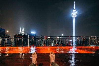 Illuminated roof top swimming pool at night in the city