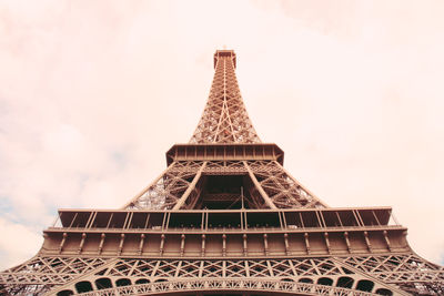 Low angle view of eiffel tower against cloudy sky