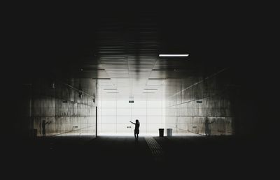 Silhouette girl standing in subway