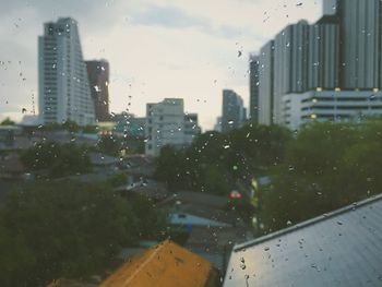 Building seen through wet glass window