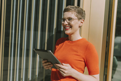 Portrait of smiling young man using mobile phone