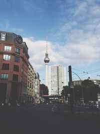 Buildings against cloudy sky