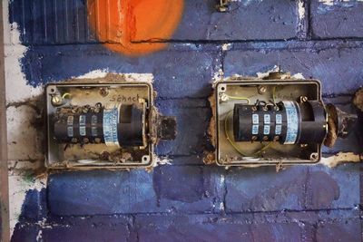 Close-up of old electric meter on wall